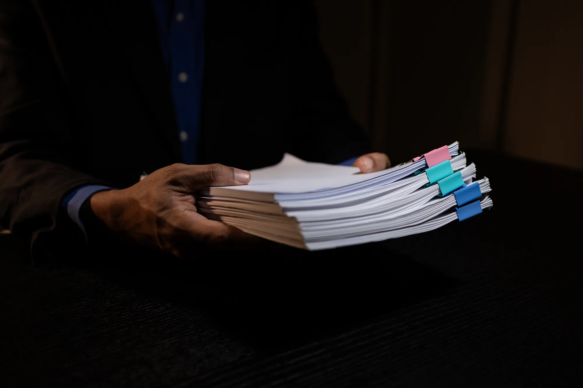 a man holding various documents